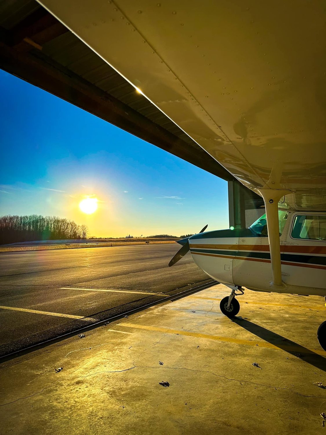 Sunlight across the airplane and hangar floor